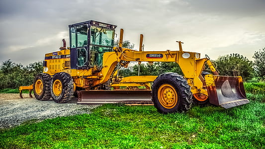 yellow excavator on green grass thumbnail