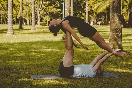 man lying on the yoga mat and carrying the woman thumbnail