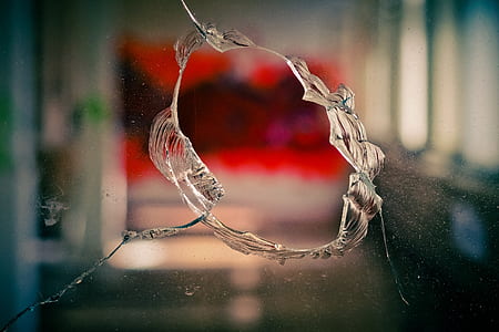 selective focus photography of circular crack on clear glass thumbnail