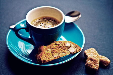closeup photo of blue ceramic teacup with saucer filled by coffee thumbnail