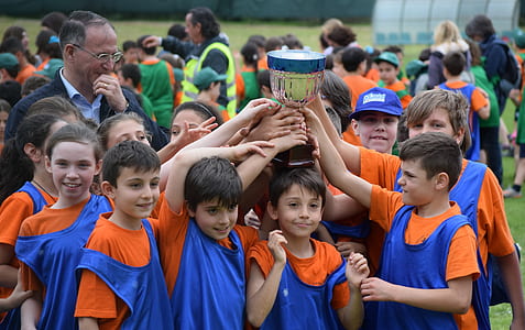 group of boy holding trophy outdoors thumbnail