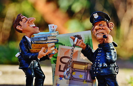 two blue-and-beige ceramic officeman and policeman figurines selective focal photo thumbnail