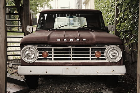 black Dodge pickup truck under stair thumbnail