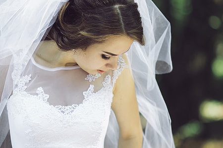 woman in white wedding dress with veil in close-up photo thumbnail