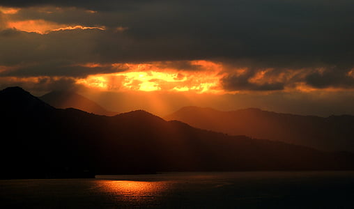 mountains under gray sky during golden hour thumbnail
