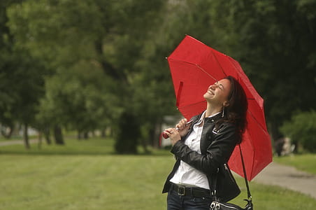 woman in black jacket holding umbrella thumbnail