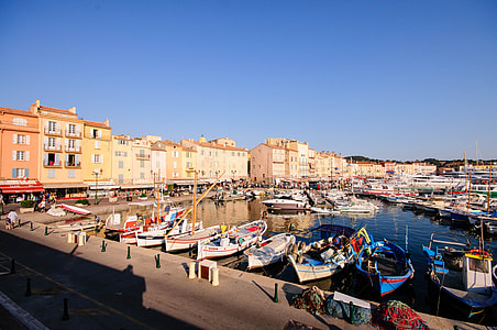 boats in body of water surrounded by architectures thumbnail