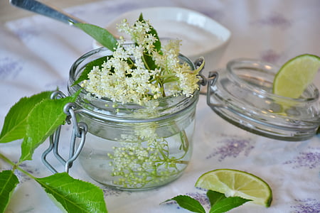 white clustered flowers in clear jar with lid thumbnail