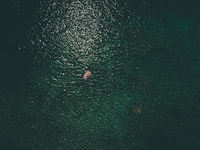 top view photography of person lying on waterbed thumbnail