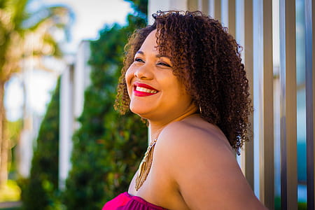 shallow focus photography of woman in pink strapless top thumbnail