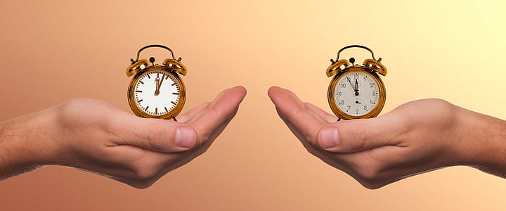 person holding bell alarm clocks thumbnail