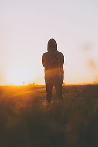focus photography of person standing facing sun ligh t thumbnail