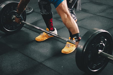 Person About to Start Lifting the Barbell Inside the Gym thumbnail
