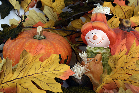 snowman wearing green and brown jumper with jack-o-lantern decor thumbnail