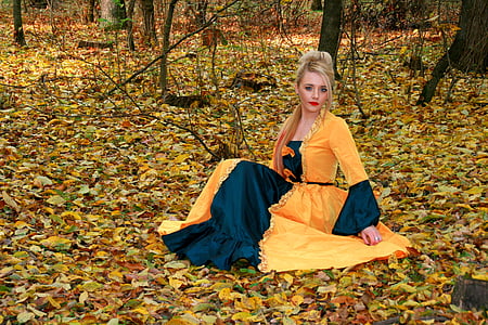 woman in yellow bindali dress sitting on the grass thumbnail