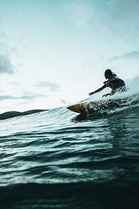 person surfer on sea wave at daytime thumbnail