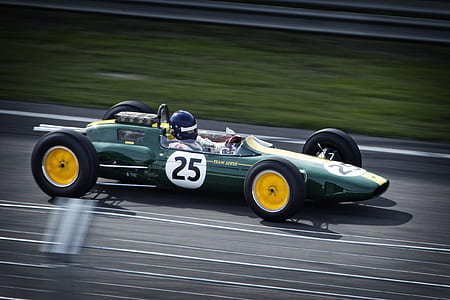 man riding F1 car on road at daytime thumbnail