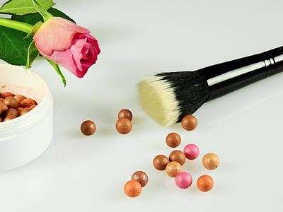 black makeup brush with bronzers on white surface thumbnail