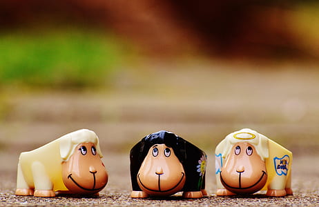 selective focus photography of three figurines thumbnail