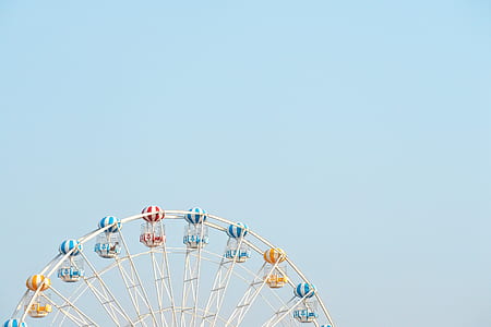 yellow, white, and blue ferris wheel during daytime thumbnail