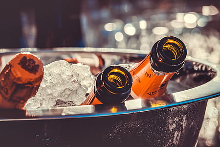 closeup photo of liquor bottles on bucket with ice thumbnail