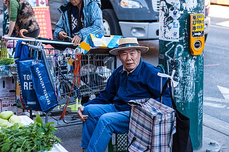 man sitting down beside luggage bag thumbnail