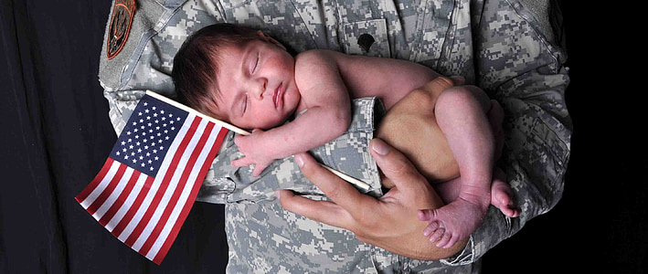 soldier carrying baby with U.S.A. flag thumbnail