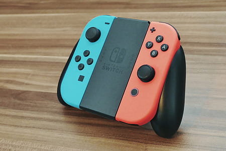 blue and orange Nintendo Switch on table thumbnail