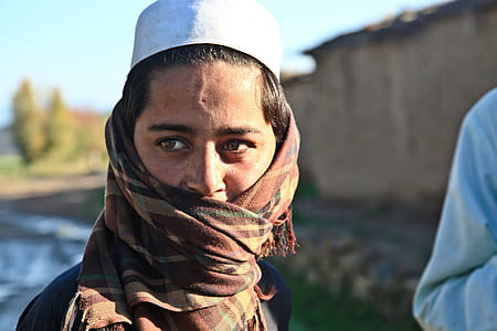 selective focus photography of man wearing scarf thumbnail