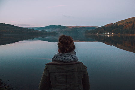 person standing front of body of water thumbnail