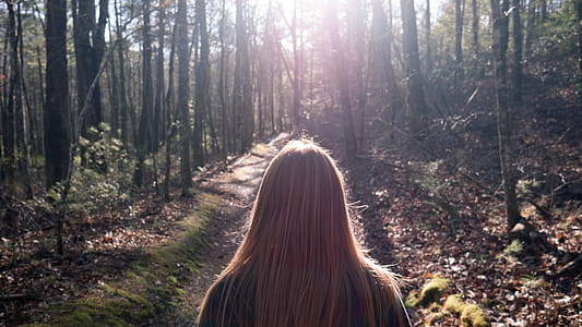 Woman in Black Top Standing Between Trees thumbnail