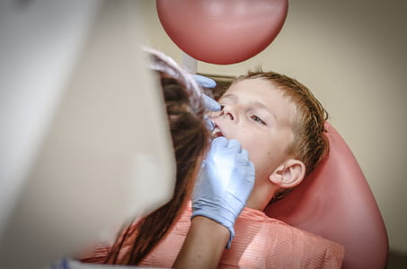 dentist checking boy's teeth thumbnail