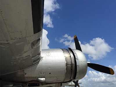 gray propeller plane under blue clouds thumbnail