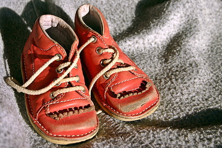 pair of toddler's red shoes on top of gray textile thumbnail