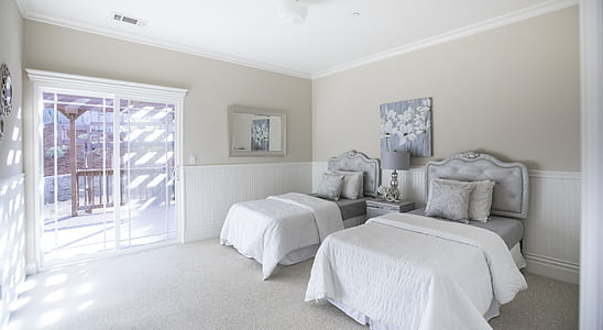 two white and grey bedspread in room thumbnail