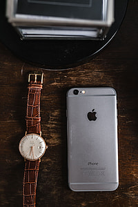 Apple iPhone 6 and Vintage watch on a brown leather wallet thumbnail