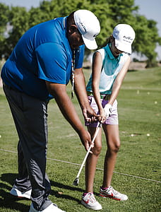 Man Teaching Girl How to Putt thumbnail