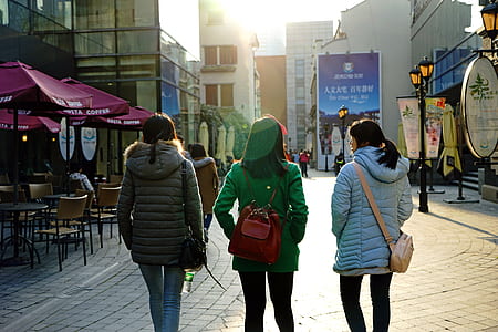 three woman walking on street thumbnail