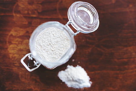 jar of white powder on brown surface thumbnail