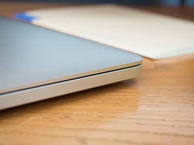 gray laptop computer placed on brown wooden board thumbnail