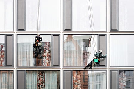 two men wiping high-rise building glass windows thumbnail