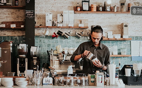 man wearing black dress shirt pouring coffee on mug thumbnail