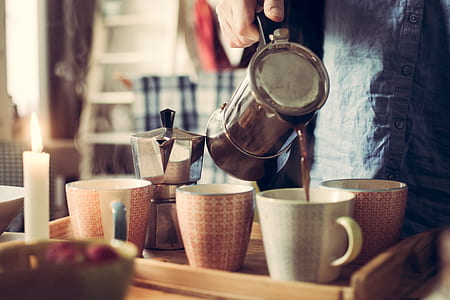 person pouring coffee on white coffee cup thumbnail