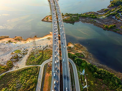 cars travelling on concrete bridge at daytime thumbnail