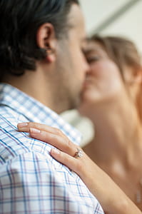 woman and man kissing selective focus photography thumbnail