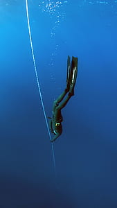 person holding rope under the sea thumbnail