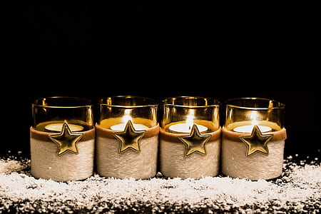 four clear votive candles inlined on gray surface thumbnail