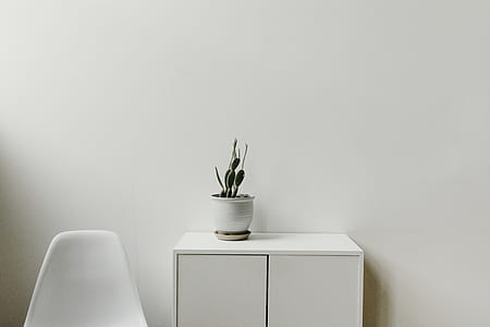 gray ceramic vase on white wooden cabinet thumbnail