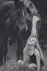 horse looking at girl wearing black spaghetti strap top thumbnail