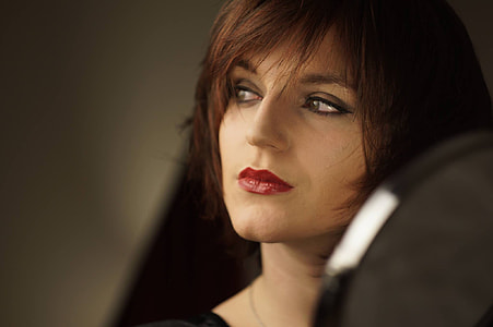 focus photography of woman wearing red lipstick thumbnail